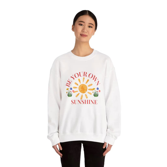 Person wearing a white sweatshirt with a sun graphic and text on a white background